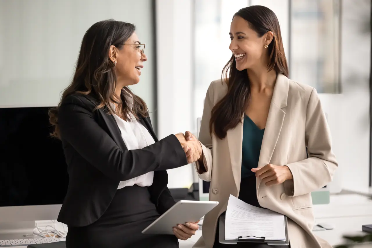 Two women shaking hands